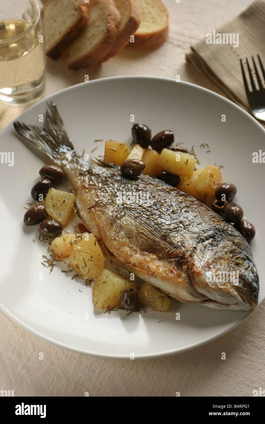 Gilthead bream with potatoes and olives  Italy Stock Photo
