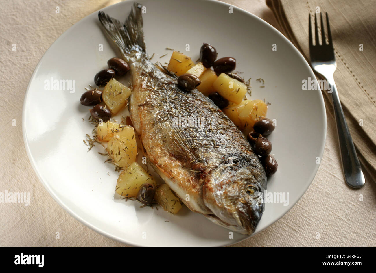 Gilthead bream with potatoes and olives  Italy Stock Photo