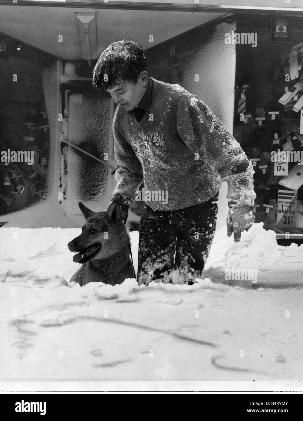 One man George Williams and his dog pictured in Clifton Street Cardiff after a heavy snowfall 3rd February 1963 Stock Photo