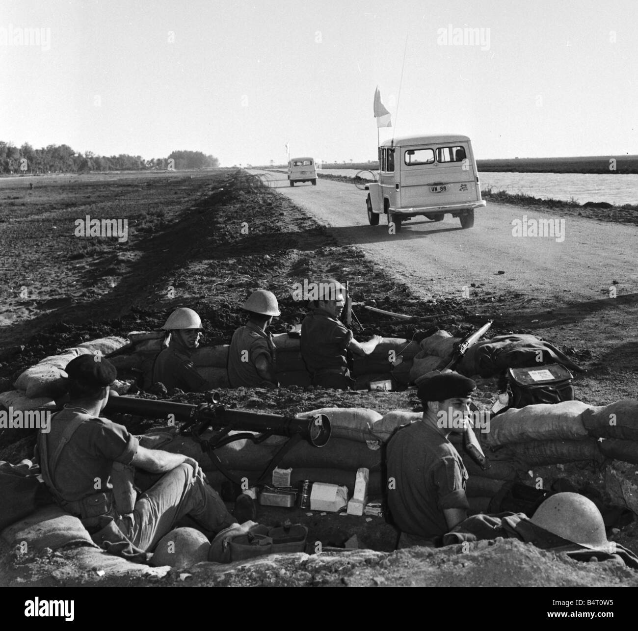 Suez Crisis 1956 British troops of the Royal Welsh Kent Regiment watch as UNO vehicles drive through their front lines on route Stock Photo
