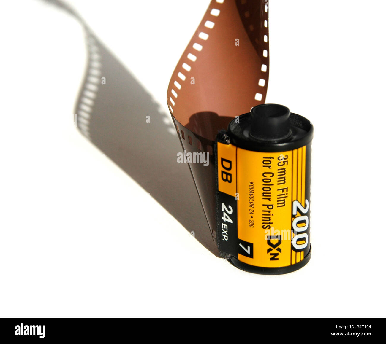 A section of 35mm film and film cassette. Stock Photo