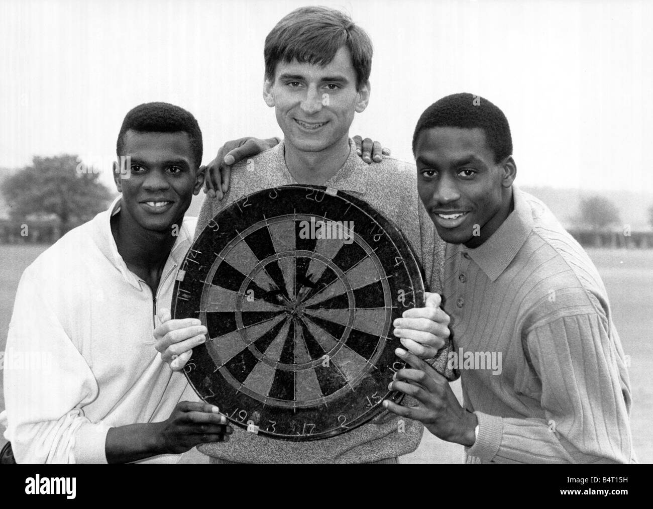 Gus Caesar Football Player of Arsenal April 1988 with teammates Paul Davis L and Alan Smith C holding a Darts Board Stock Photo