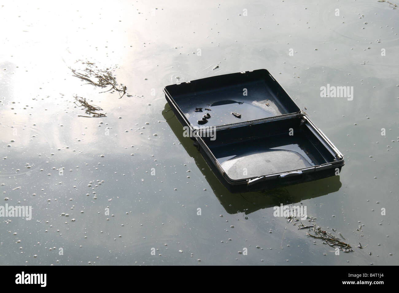 one empty suitcase luggage floating in river Stock Photo - Alamy