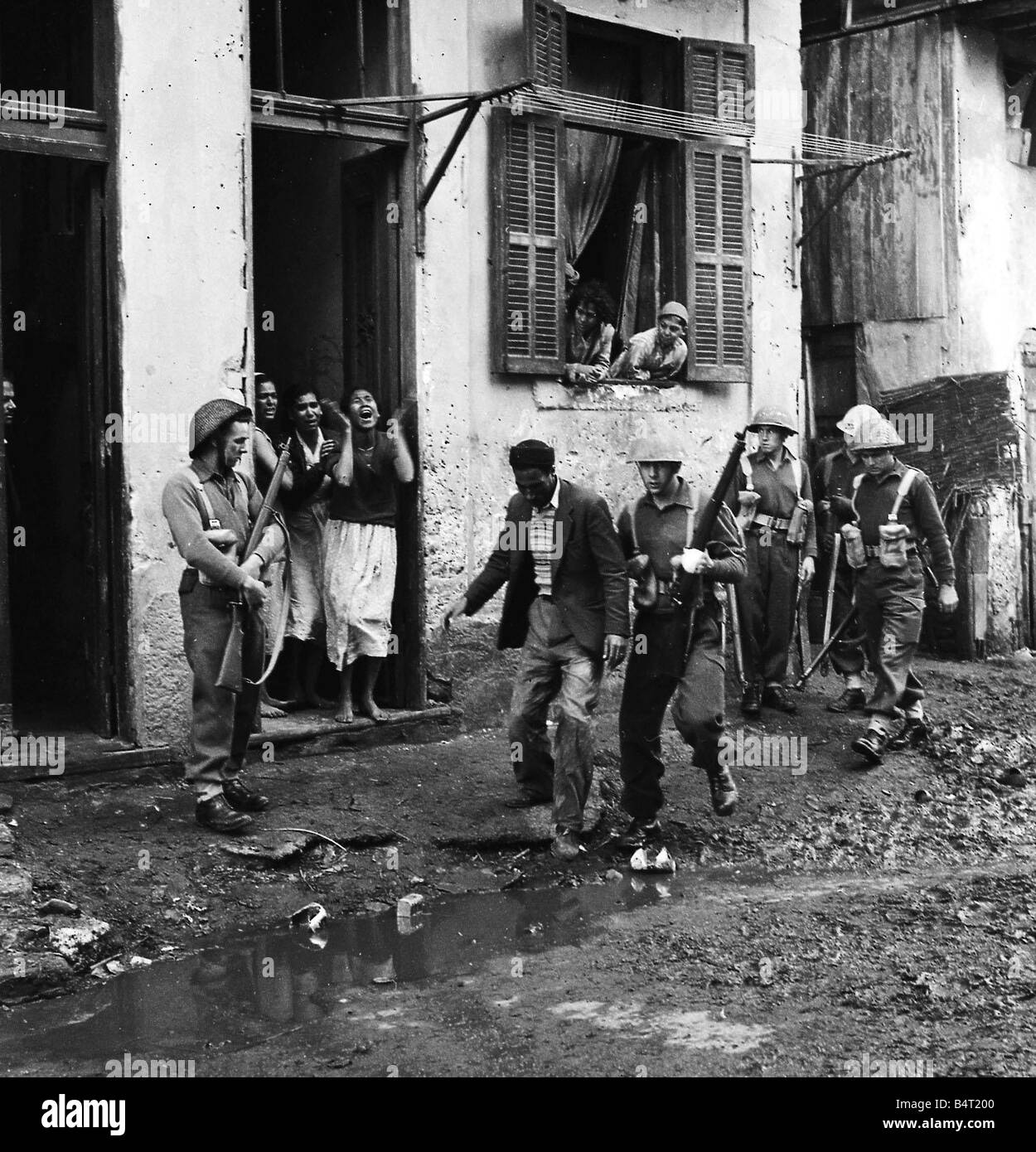 Suez Crisis 1956 Troops of D Company 1st Battalion Argyll and Sutherland Highlanders carry out a search of houses in the Arab Town district of Port Said after a hand grenade was thrown at an army jeep The seach yielded thirteen rifles some of which were of Russian origin Six arabs were arrested Stock Photo