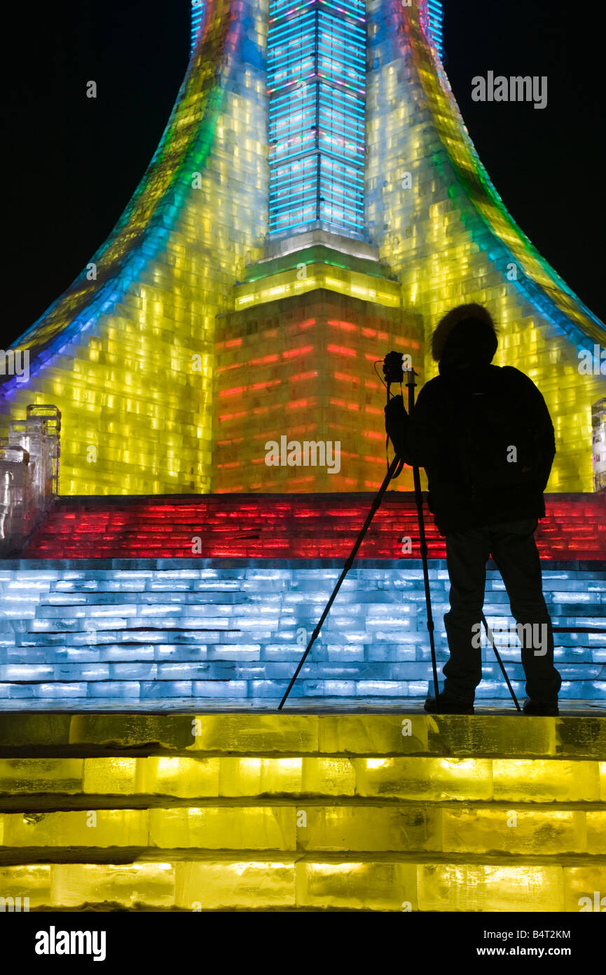 China, Heilongjiang, Harbin, Ice and Snow Festival, Photographer Silhouette at Ice Olympic Tower Stock Photo