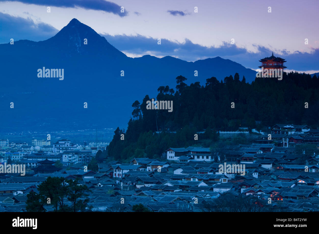China, Yunnan Province, Lijiang, Old Town Rooftops & Pavillion Tower atop Shizi Shan Stock Photo