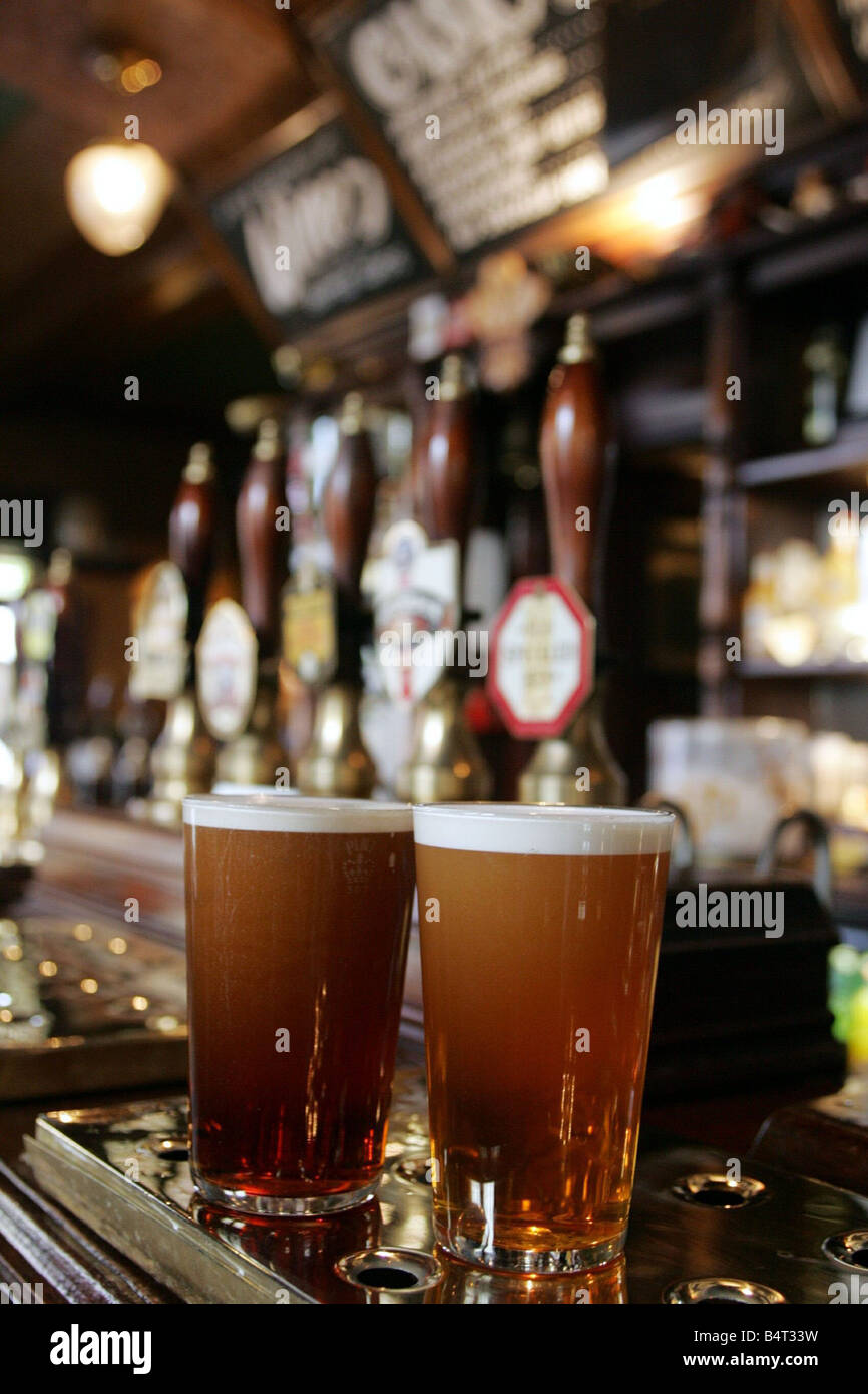 A pair of pint glasses on the bar in a pub Stock Photo - Alamy