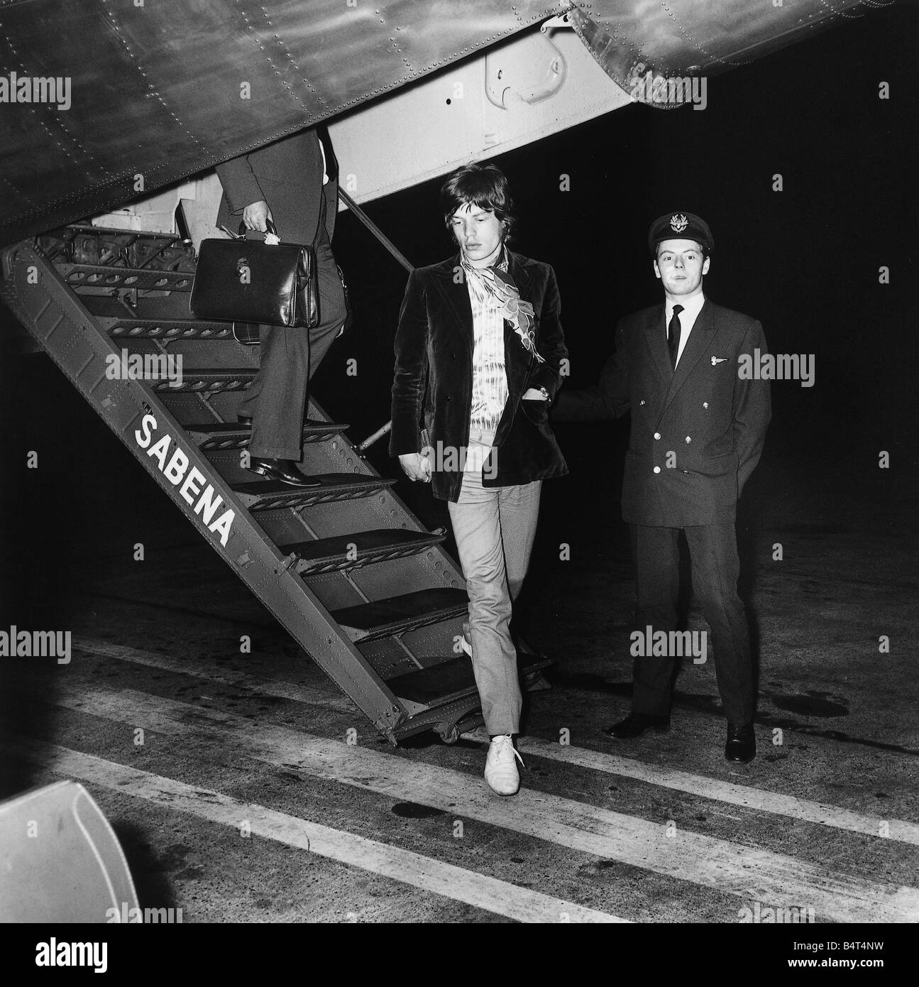 Rolling Stones lead singer Mick Jagger disembarks from his return