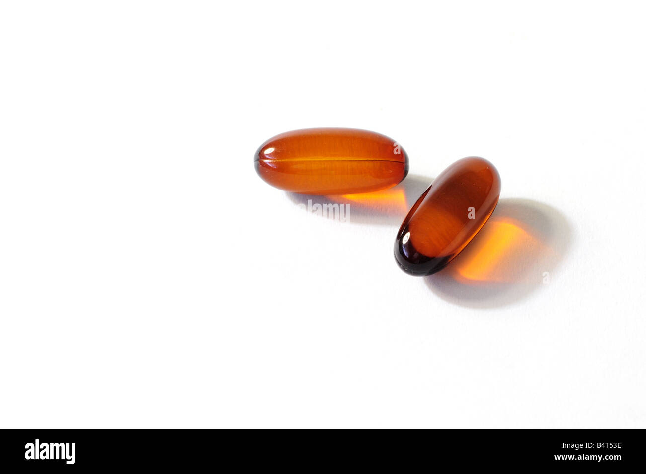 Two omega 3 and 6 flaxseed oil capsules on a white background. Silo, cutout. USA. Stock Photo