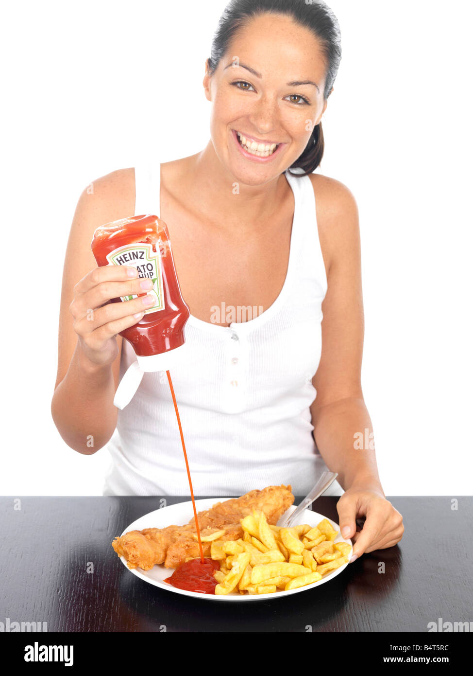 Young Woman Putting Ketchup on Fish and Chips Model Released Stock