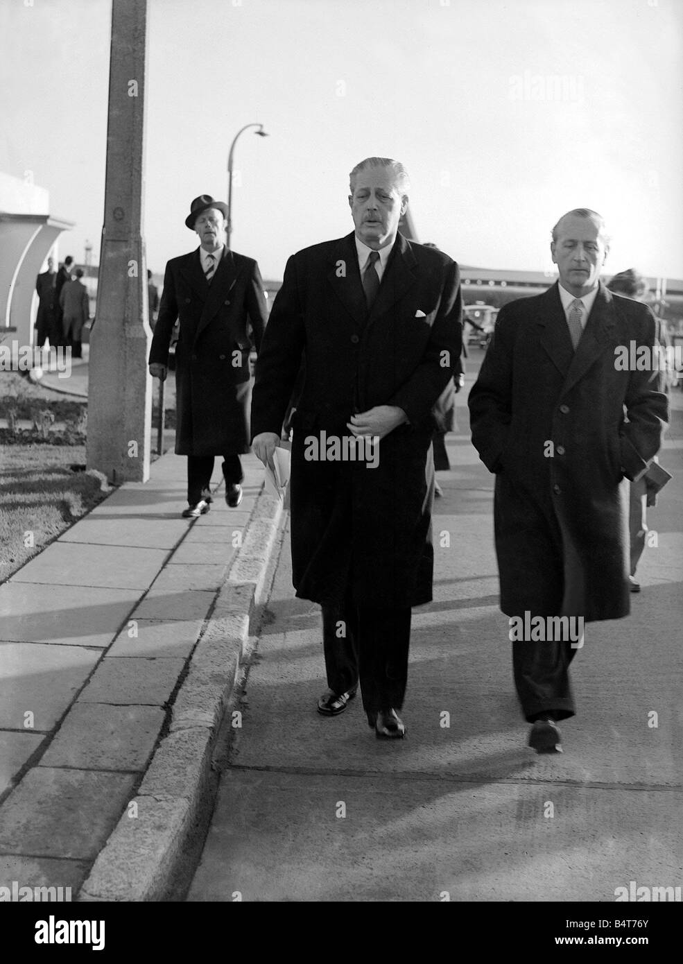 Harold MacMillan leaving London for his World Tour January 1958 Prime Minister Harold MacMillan accompanied by a government official walking to the Britannia aircraft at London Heathrow airport Stock Photo