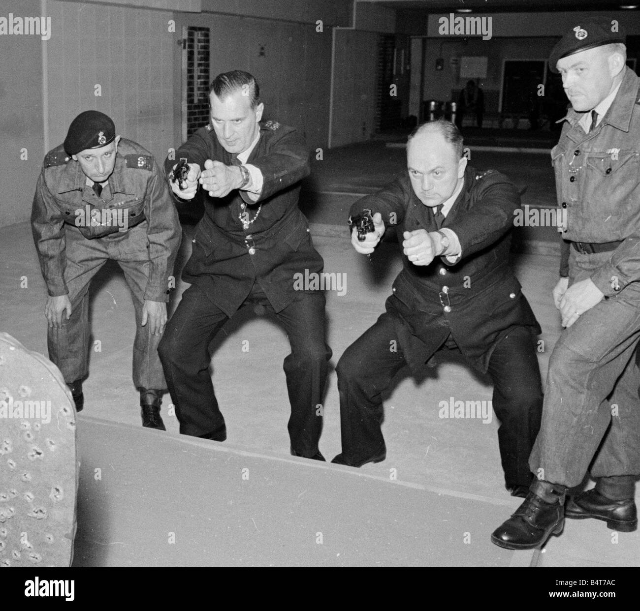 Police officers training with firearms during a four day course at City Road Police station indoor range April 1967 Stock Photo