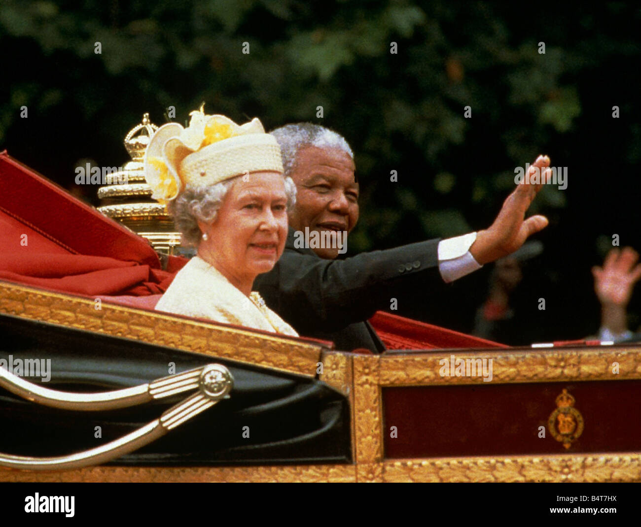 Nelson mandela waves from the carriage as he sits beside Her Majesty Queen Elizabeth II during his visit to England July 1996 Stock Photo