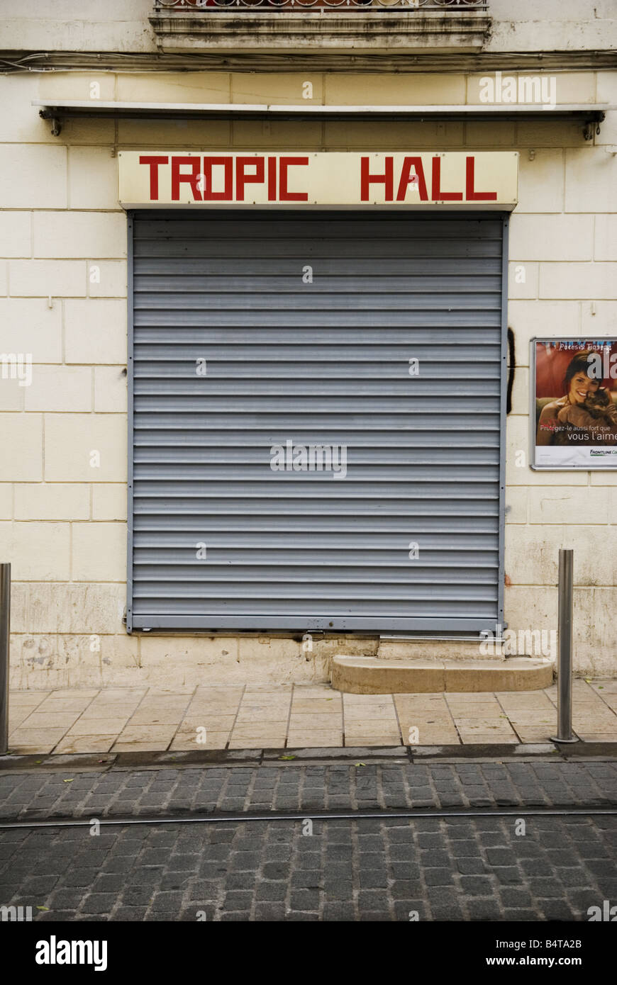 facade of closed shop with security shutters in france, called 'Tropic Hall' Stock Photo