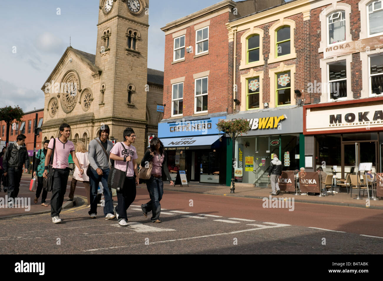 A Group of young teenage students crossing the road Fishergate Preston city centre Lancashire England UK Stock Photo