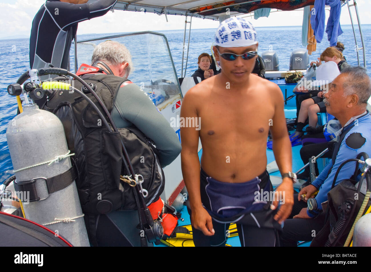 Divers preparing to go scuba diving off Sipadan Island nr Semporna