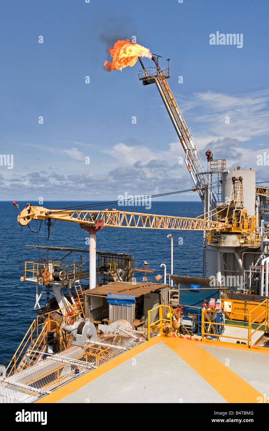 Offshore oil and gas production marine rig showing safety flare off coast of Gabon Stock Photo