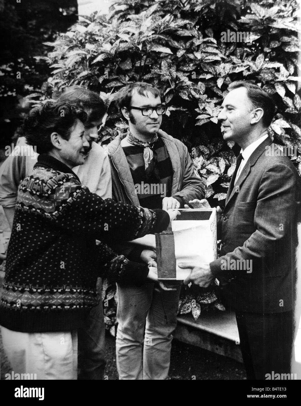 Pacifist campaigner Pat Arrowsmith ahands a biscuit tin full of