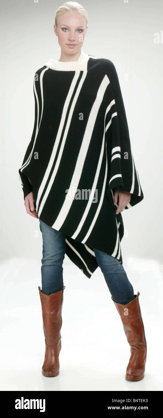 Catwalk Copies Fashion Clothing Feature September 2004 Clothes copy copied Woman wearing dress Clothes copy copied Woman wearing black and white striped poncho with blue denim drainpipe jeans and brown knee high boots Studio Pix Stock Mirrorpix Stock Photo