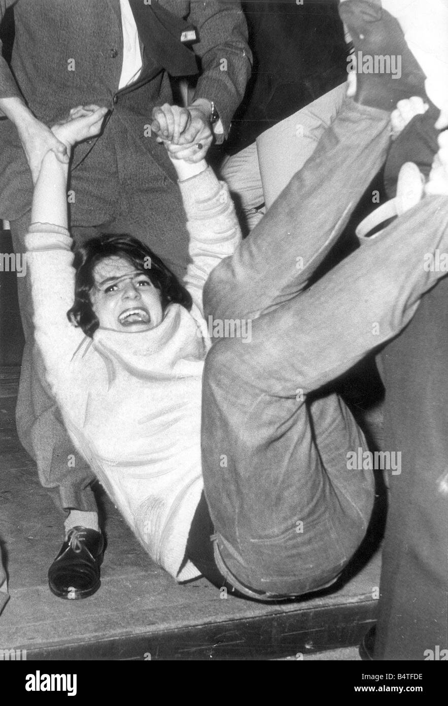 A Rolling Stones fans has to leave the City Hall early in October 1965 Stock Photo