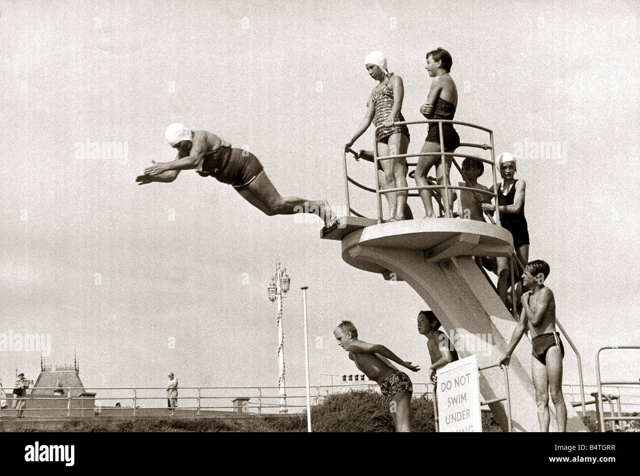 Taking The Plunge Diving board is 16ft 6in Diver soaring from it is 75 year old Molly Pendleton