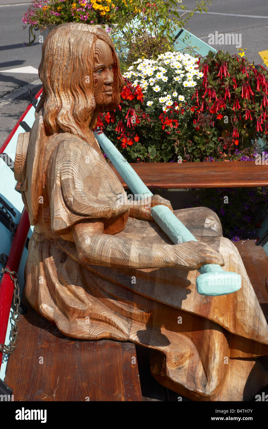 Wooden carving of a lady in a rowing boat Stock Photo