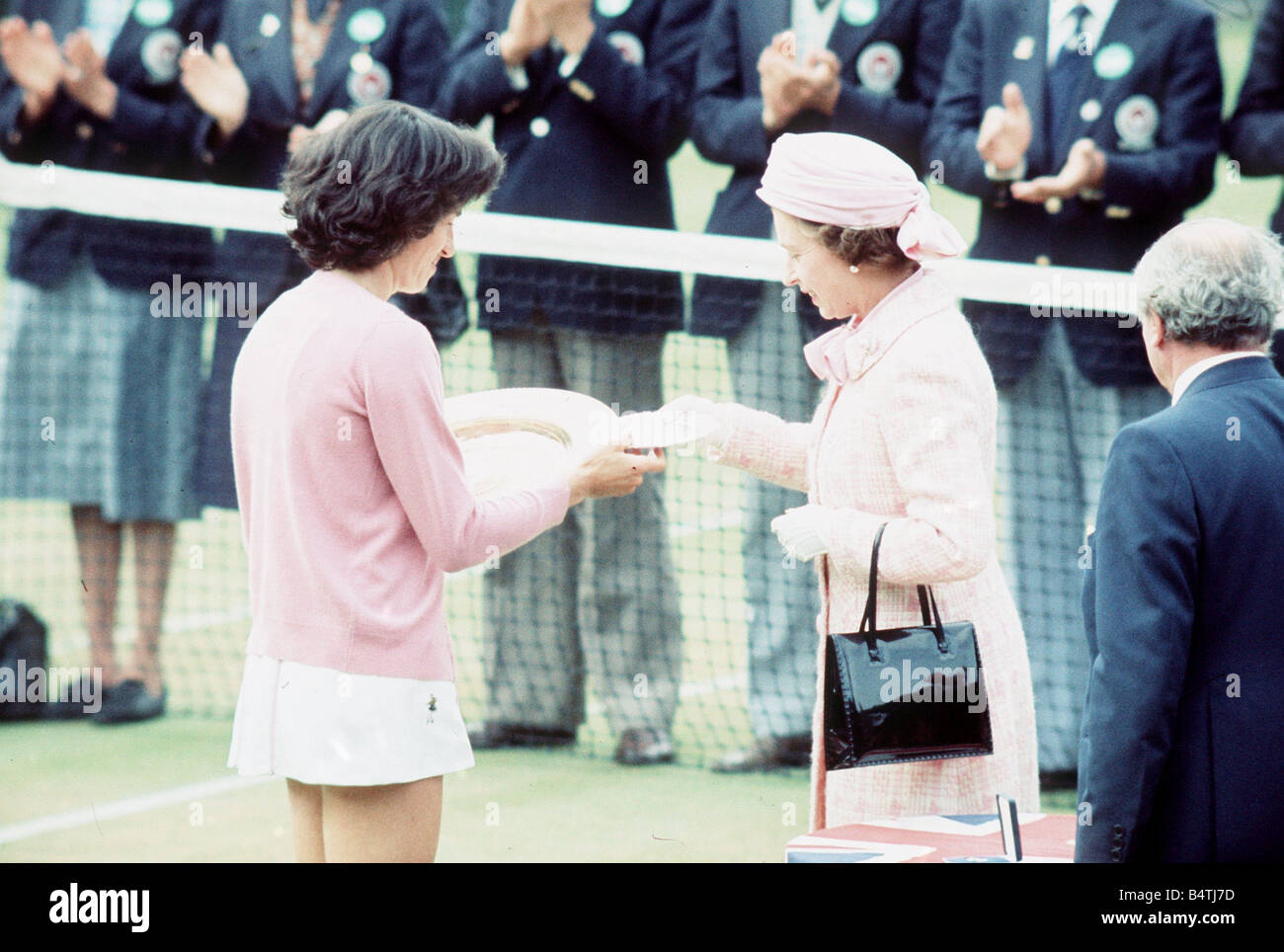 Virginia Wade receives the Wimbledon womens trophy 1977 from the Queen Stock Photo