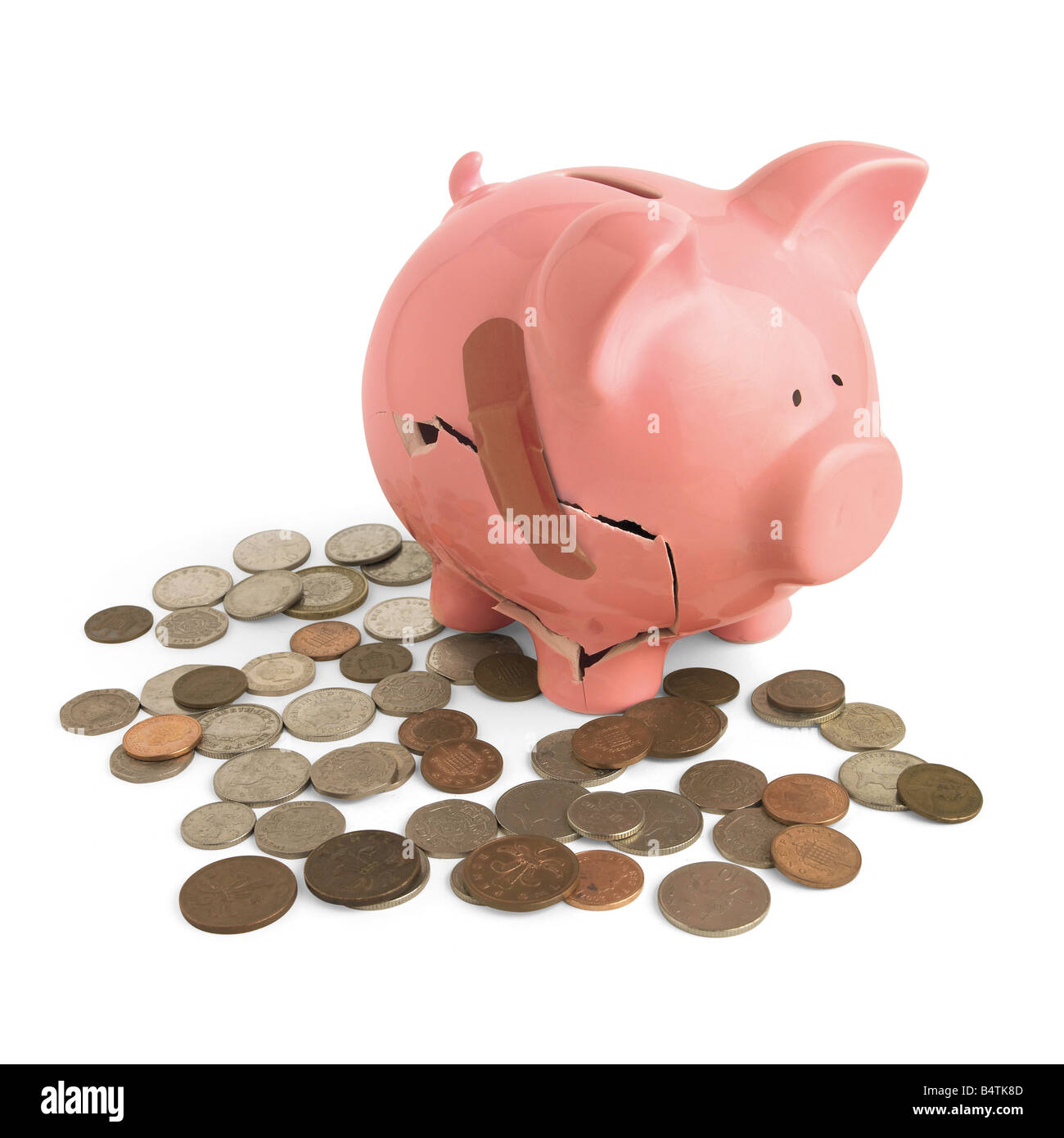 Smashed pink piggy bank, surrounded by coins Stock Photo