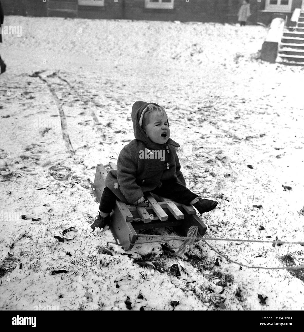 Weather Snow Cold Children Helen Brown 2 years old decides sledging isn t as much fun as she thought and cries out her discomfort in the cold snow Stock Photo