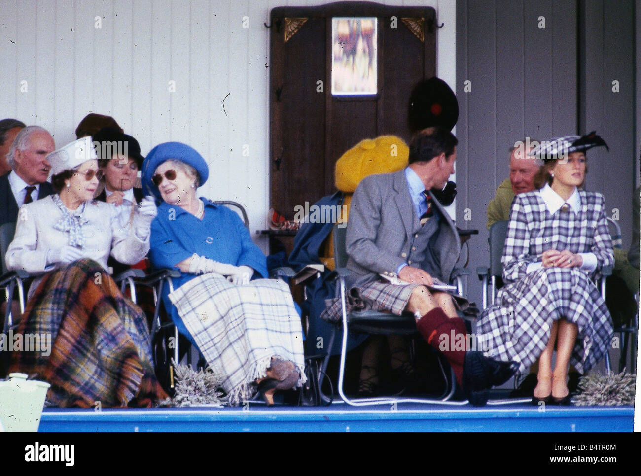 Princess Diana Princess of Wales September 1989 at Braemar games sitting with Prince Charles Queen Queen Mother C T Roy Brit Princess Diana Scotland check hat dress rug Stock Photo