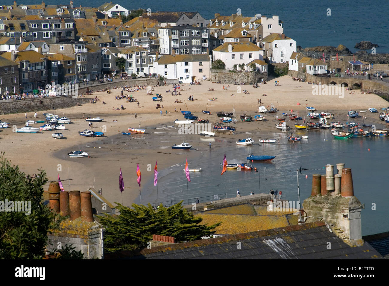 Saint Ives, Cornwall, chimneys and harbour view of beach and boats in late summer. Stock Photo