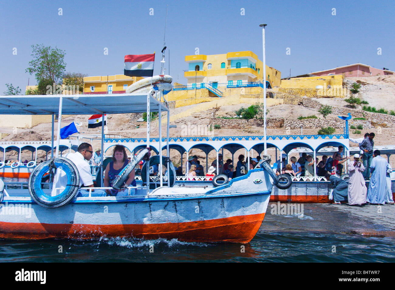 Small excursion boats take tourists out to the island Temple of Phillae in Egypt Stock Photo