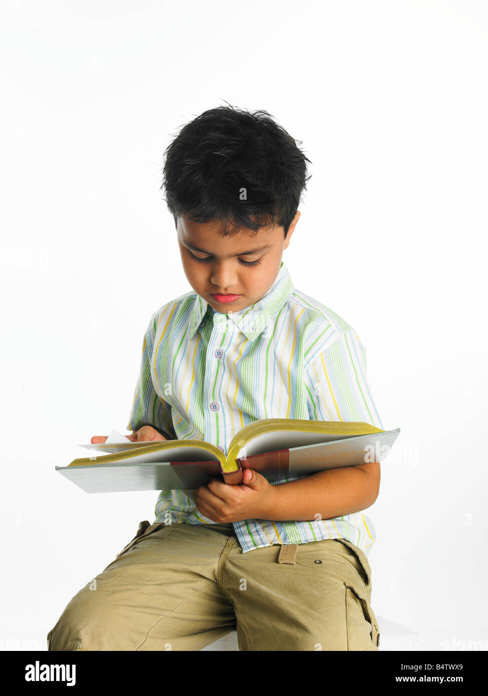 Asian boy reading a book Stock Photo