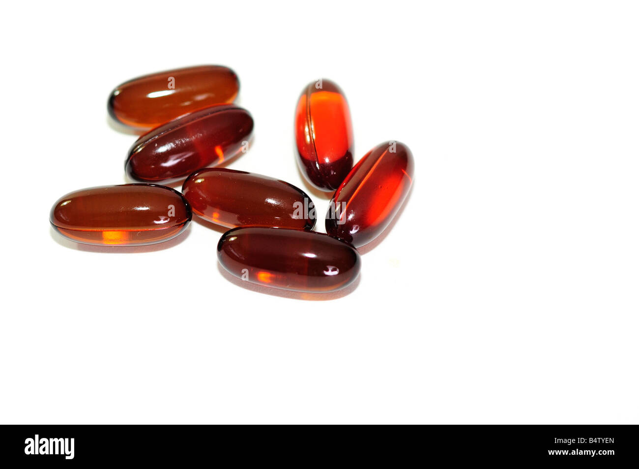 Six omega 3 and 6 flaxseed oil capsules on a white background. Silo, cutout. USA. Stock Photo