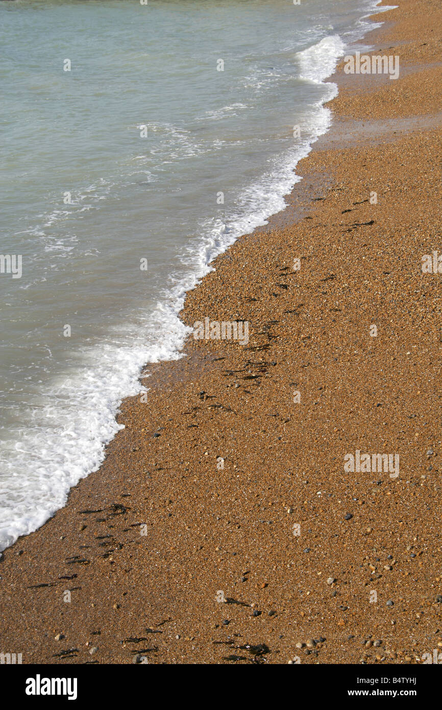 Waves Gently Lapping on a Shingle and Sand Beach, Saltdean, Sussex, UK Stock Photo