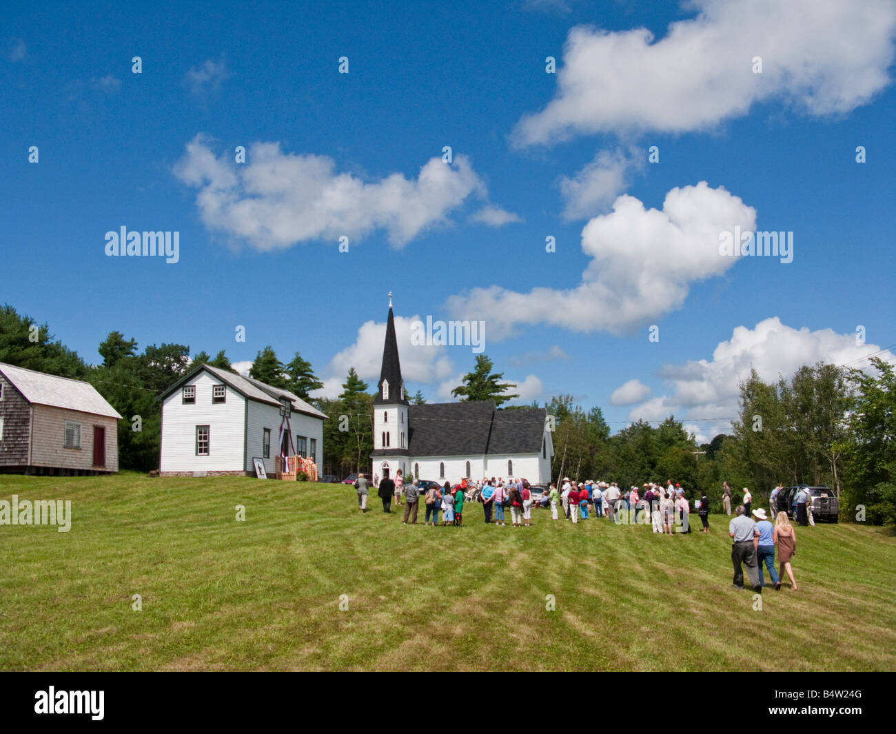 Country farm house and white clapboard church in Cambridge Narrows New Brunswick Canada Stock Photo