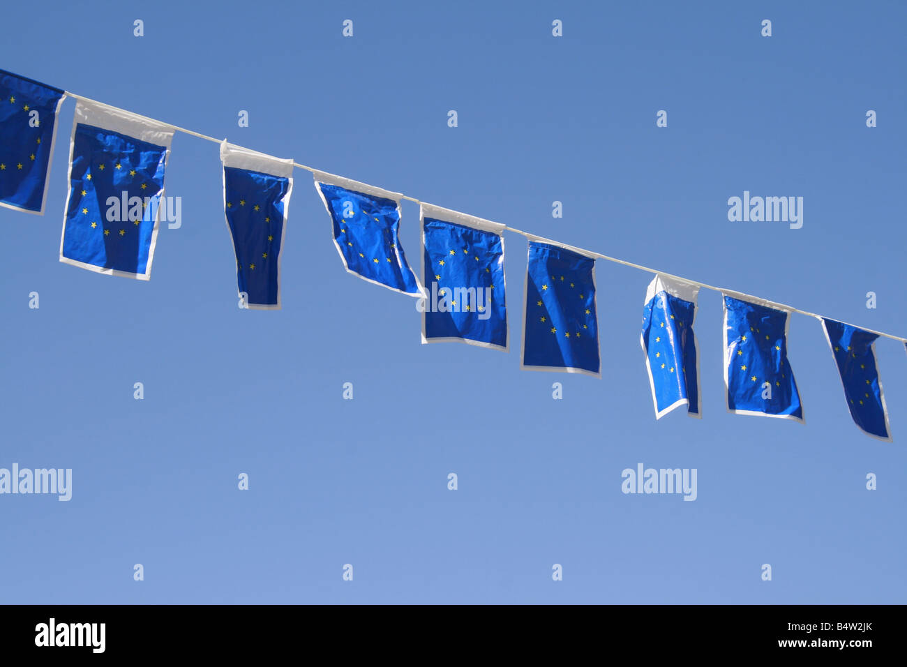 many european union flags flying in wind in sun Stock Photo - Alamy