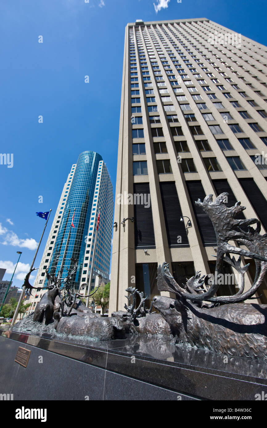 Bronze sculpture of caribous crossing river, outside the Richardson Building with the Canwest Place building Stock Photo