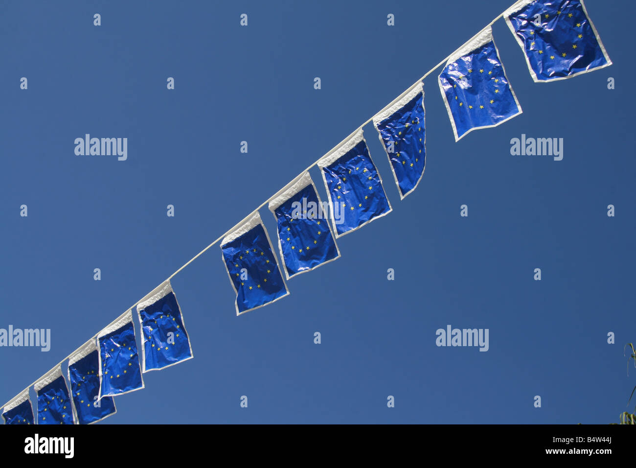 many european union flags flying in wind in sun Stock Photo - Alamy
