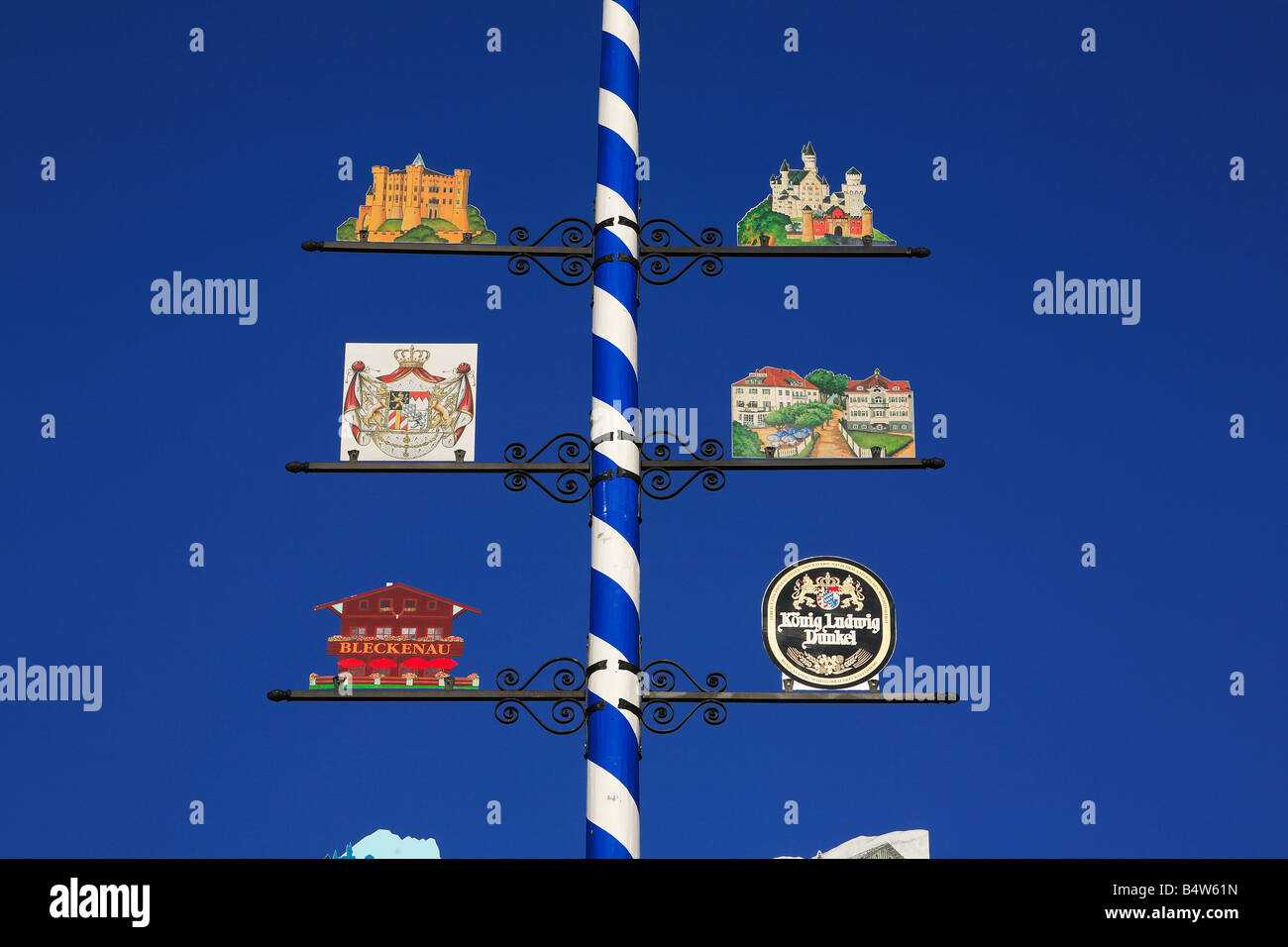 bavarian maypole with signs for the castles of Neuschwanstein and ...