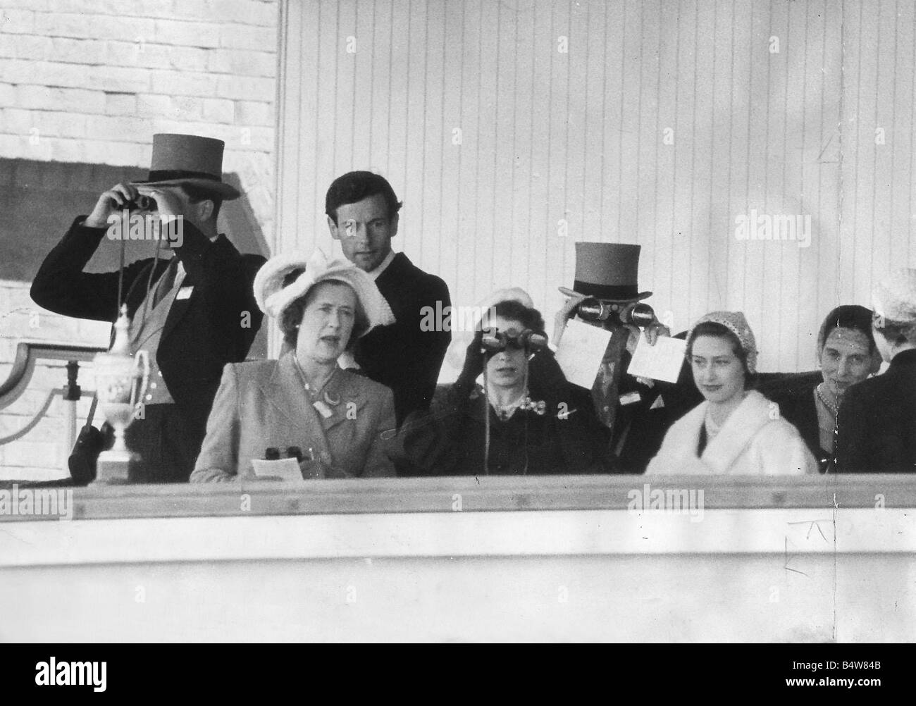 View of the Royal Box At Ascot showing Queen Elizabeth Princess Margaret White Fur Coat and Group Captain Peter Townsend hatless on left June 1952 Stock Photo