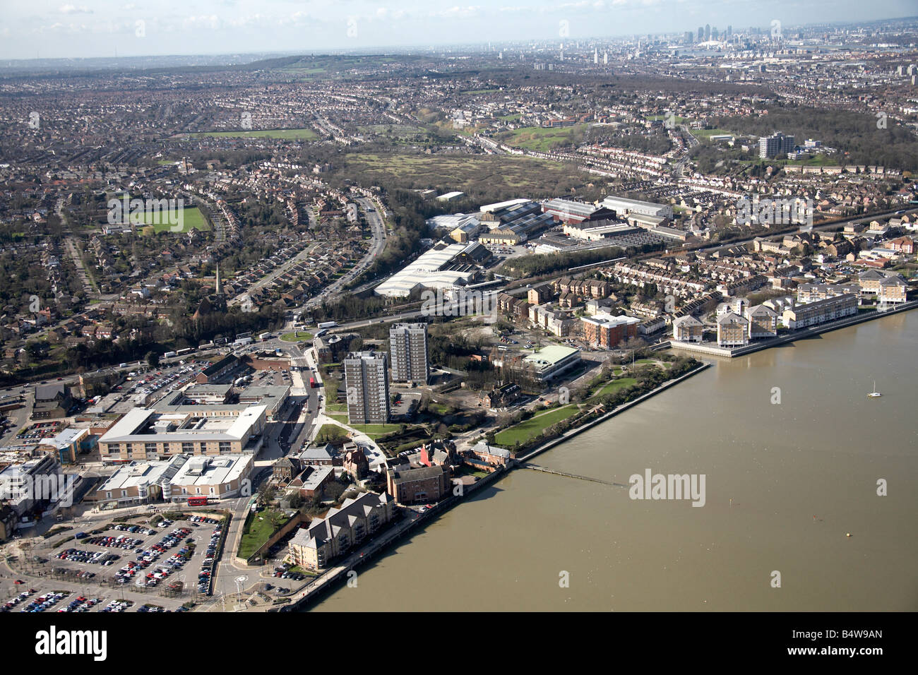 Aerial view south west of Bronze Age Way suburban houses flats tower blocks River Thames Erith London DA8 England UK Stock Photo