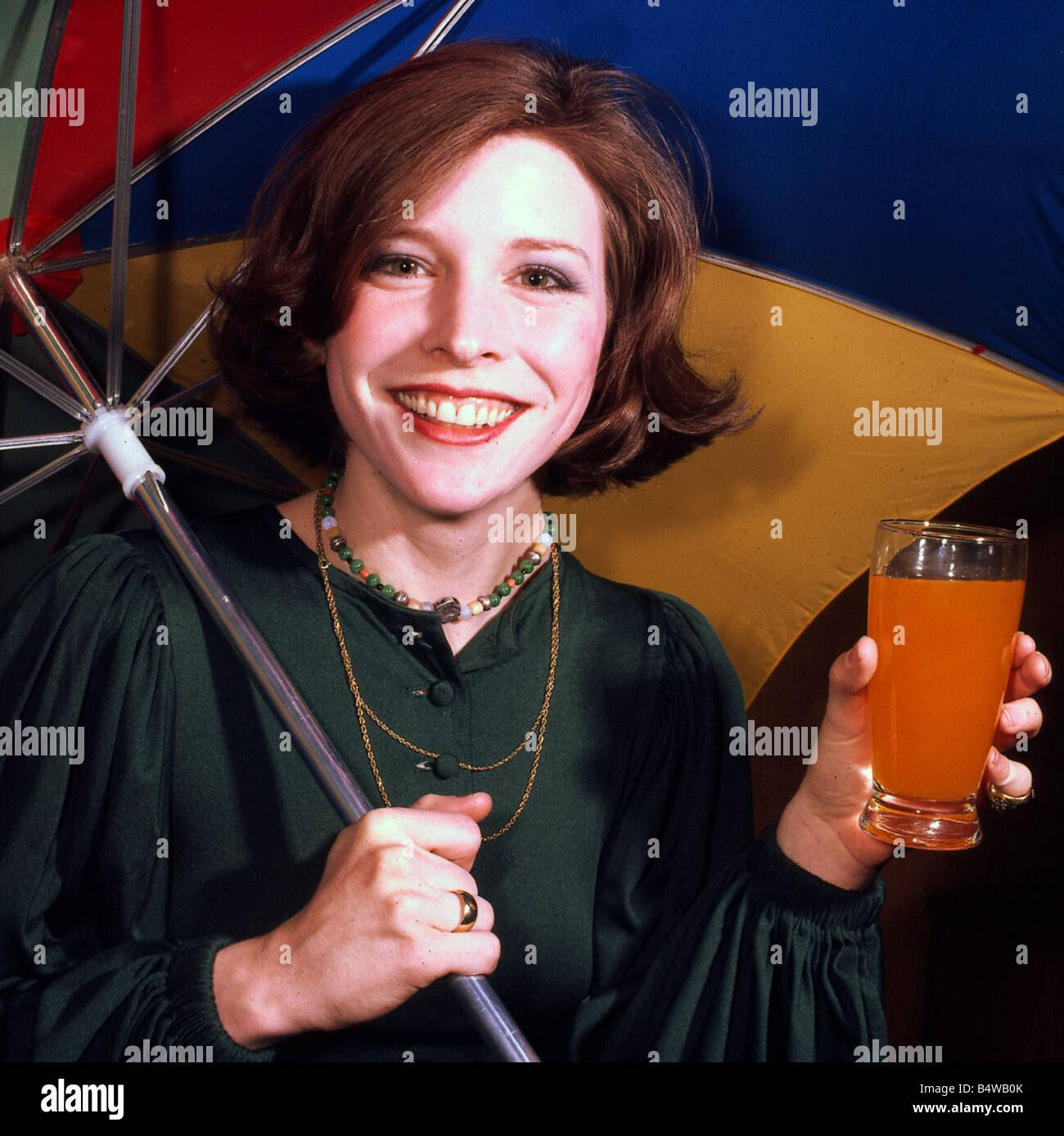 Candy Clark holding glass of orange juice March 1976 Stock Photo