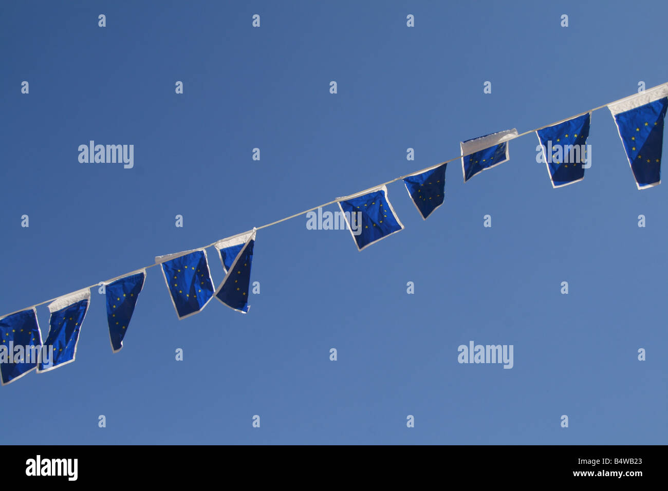 many european union flags flying in wind in sun Stock Photo - Alamy