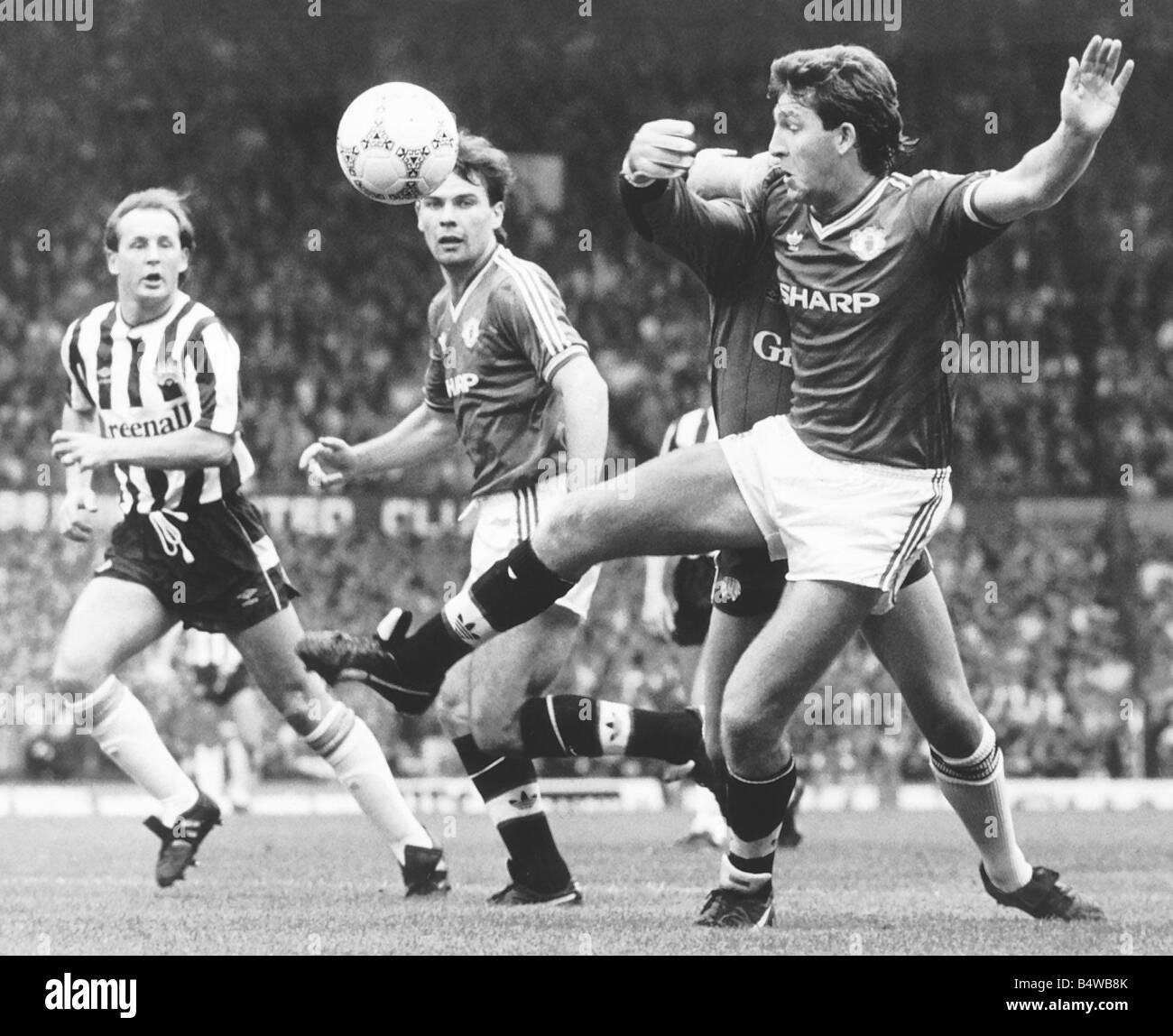 Norman Whiteside of Manchester United pushes past Gary Kelly The Newcastle keeper Mirrorpix Stock Photo