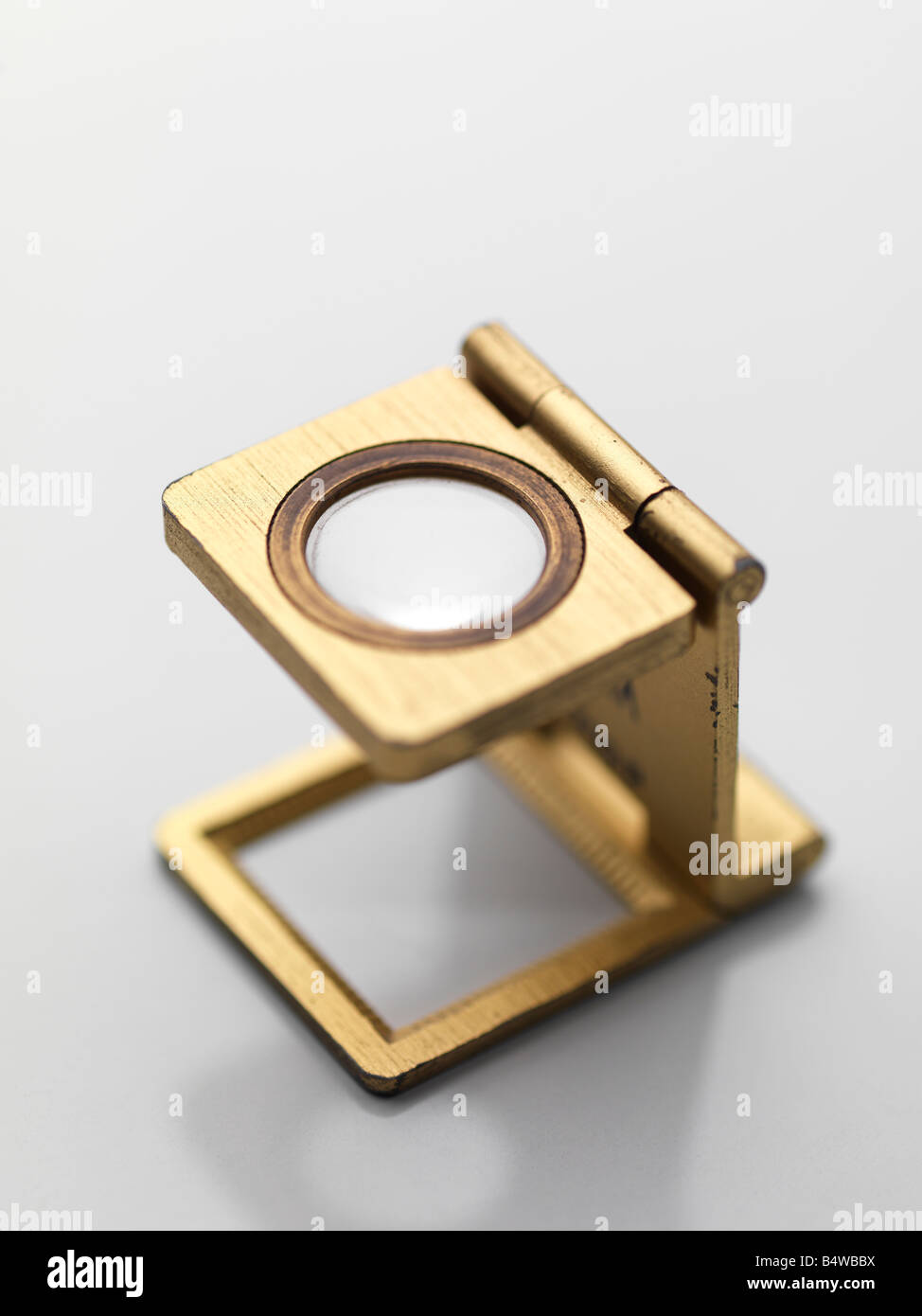 lens magnifying lens, magnifying glass golden gold metal pliant, pliable,  bendable thin, fine pocket glass eye look, glance Stock Photo - Alamy
