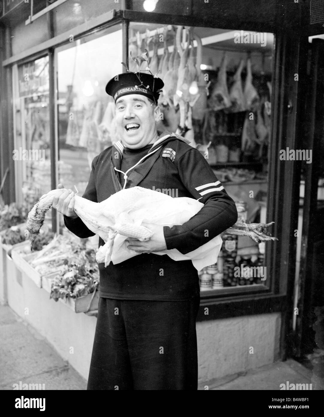 HM Submariner Bill Hayne enjoys collects the turkey for christmas dinner whilst on a shopping expedition for the sailors in his Stock Photo