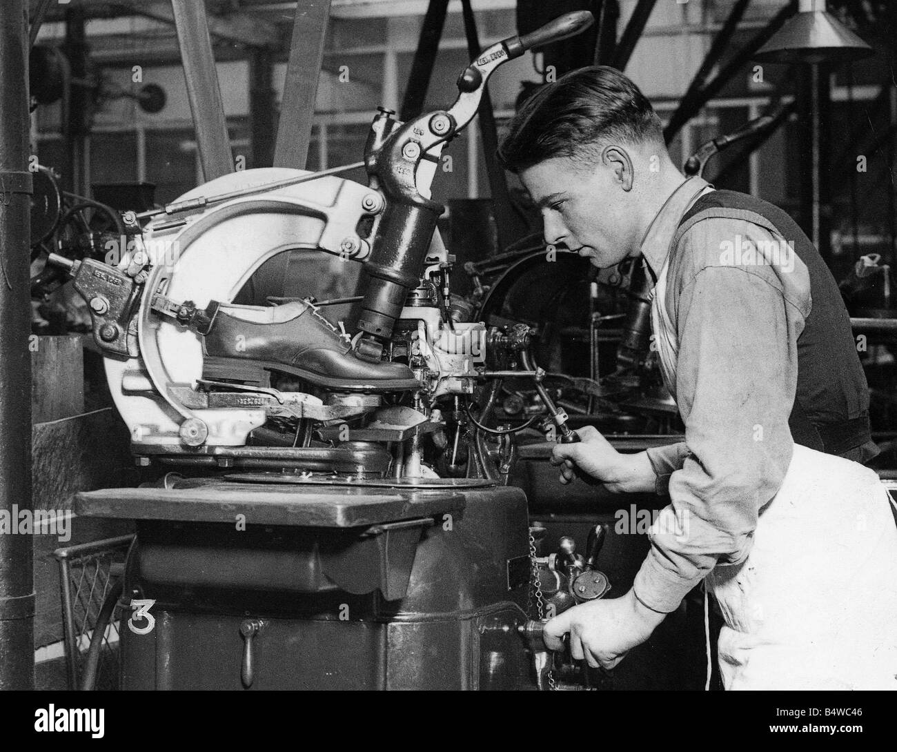 Shoe manufacture January 1935 Saxone Shoe Company Kilmarnock Machine manufacturing shoe Stock Photo
