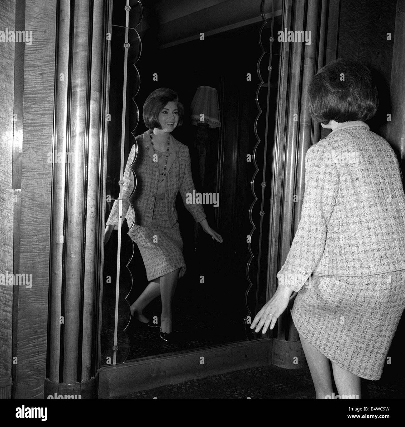 Sylva Koscina Actress Model 1964 practises her curtsey in mirror during rehearsal for the Royal Film Performance in London Stock Photo