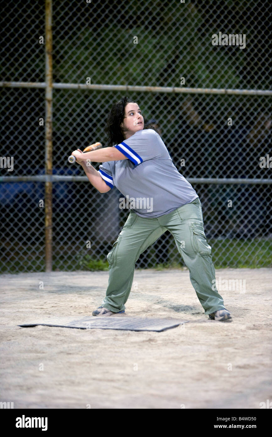 A young woman swinging a baseball bat Stock Photo Alamy